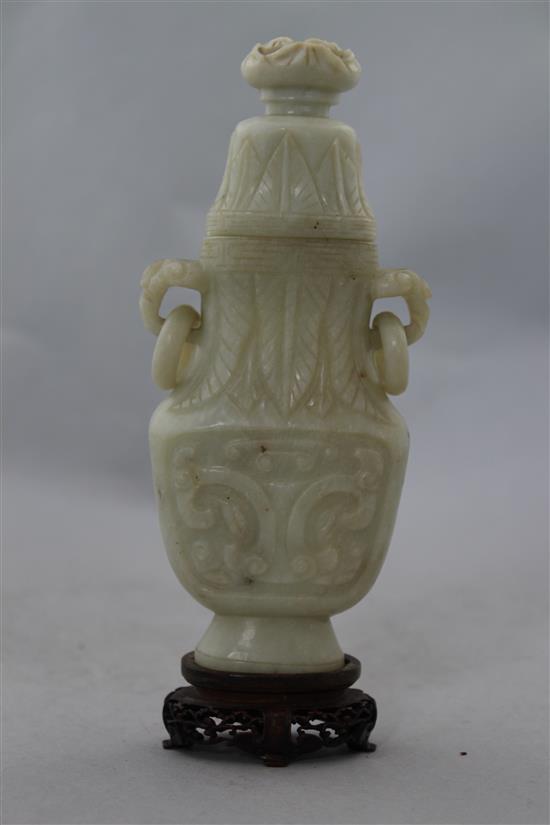 A Chinese greyish white bowenite jade archaistic vase and cover, 20th century, 17cm, wood stand